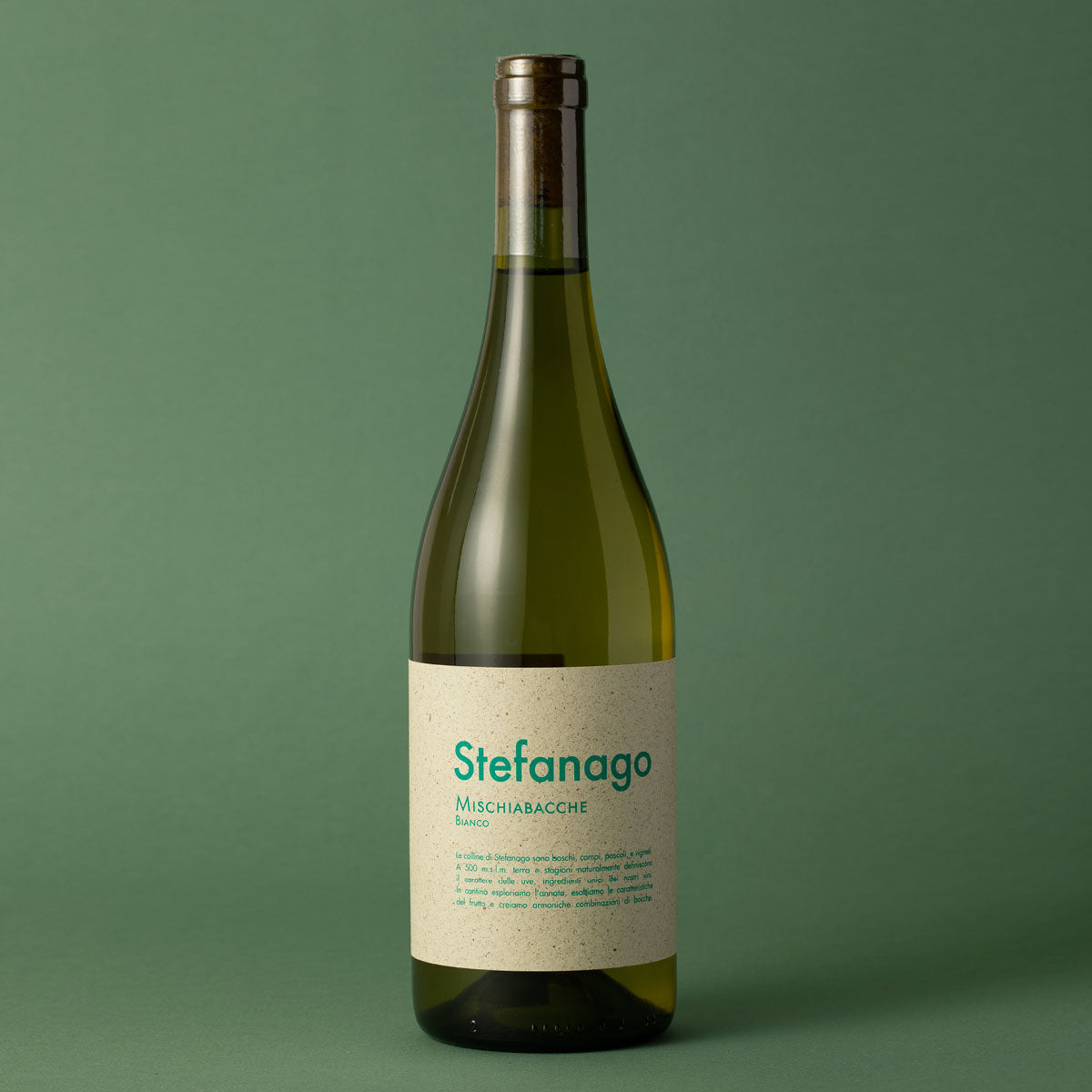Styled image of Castello di Stefanago’s Mischiabacche Bianco — an expressive natural white wine from Oltrepò Pavese, reflecting the estate’s wild farming and lo-fi winemaking approach