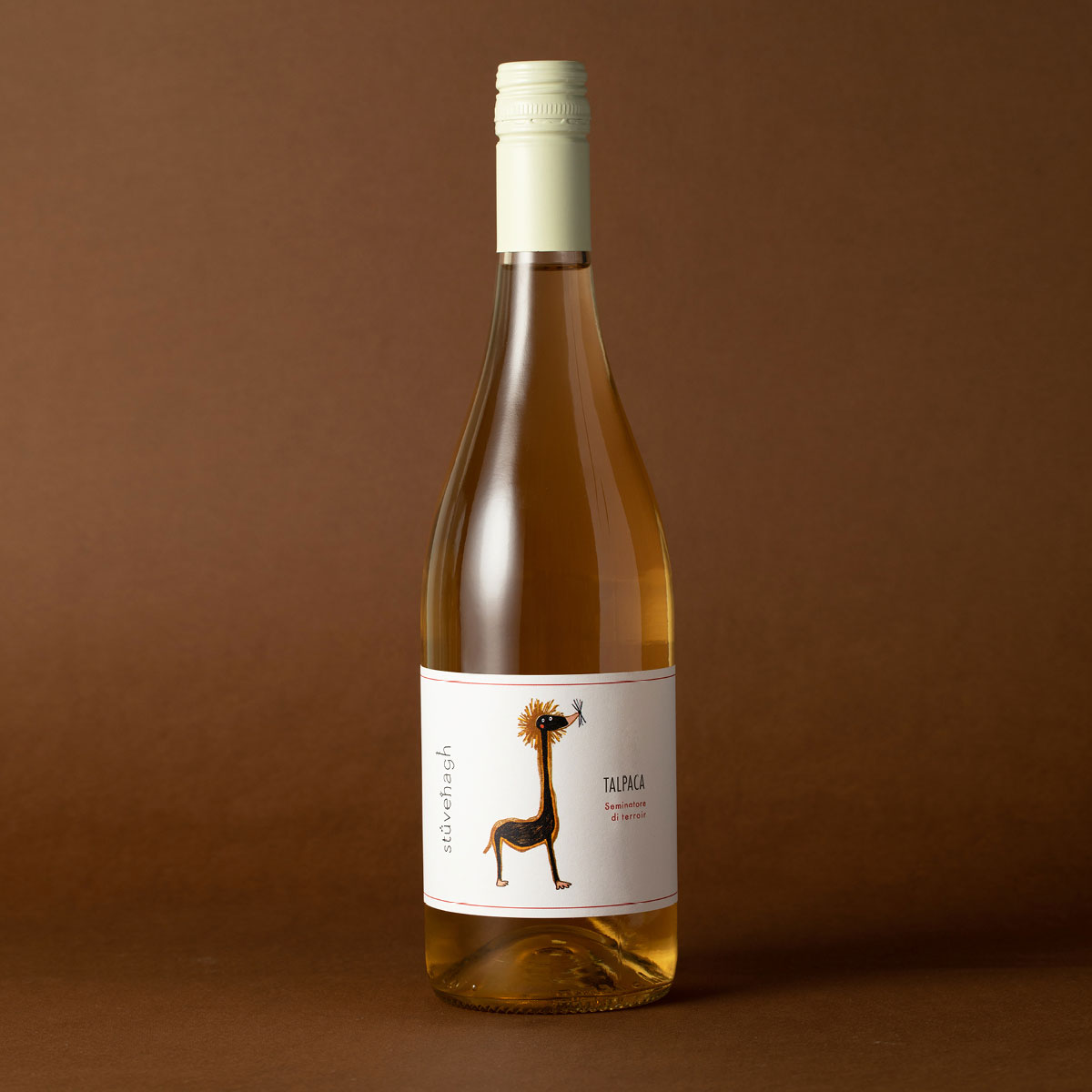 Styled image of Castello di Stefanago’s Talpàca — an organic skin-contact white wine with golden hues, reflecting the winery’s lo-fi approach and expressive terroir