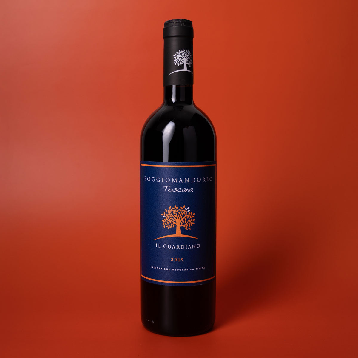 Styled image of Poggio Mandorlo Il Guardiano — a bold and elegant organic red wine from Montecucco, Tuscany, ideal for hearty meals and thoughtful pairings