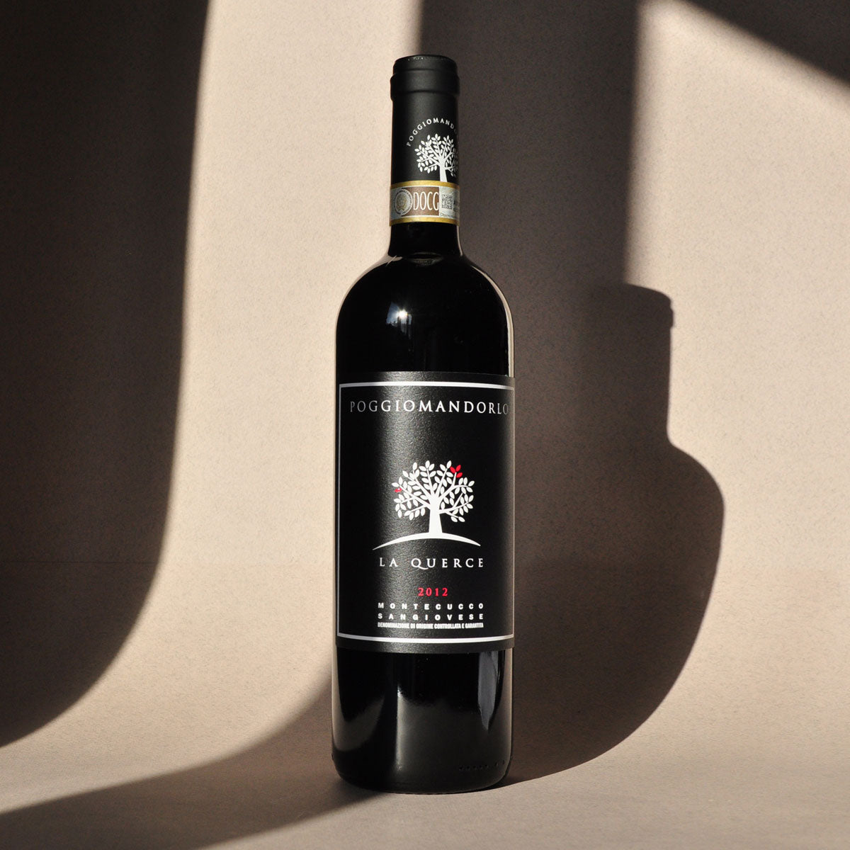 Styled view of Poggio Mandorlo Il Guardiano — a sustainably produced Sangiovese red wine from Montecucco, Tuscany, with depth and regional expression