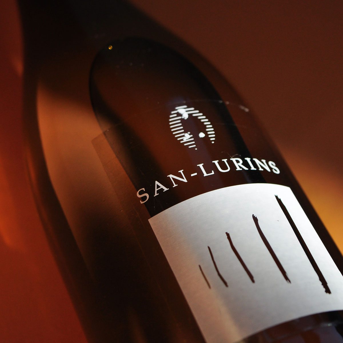 Close-up of San Lurins Malvasia Pet-Nat bottle label, showcasing the minimalist design and tribute to Friulian winemaking tradition